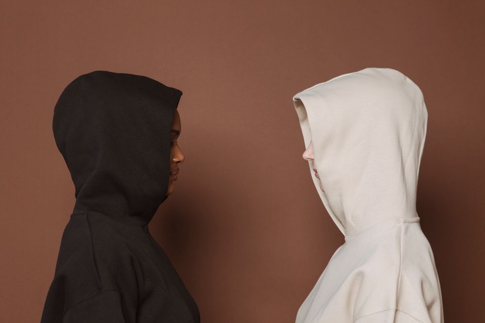 Back view of a garment-dyed hoodie in pitch black